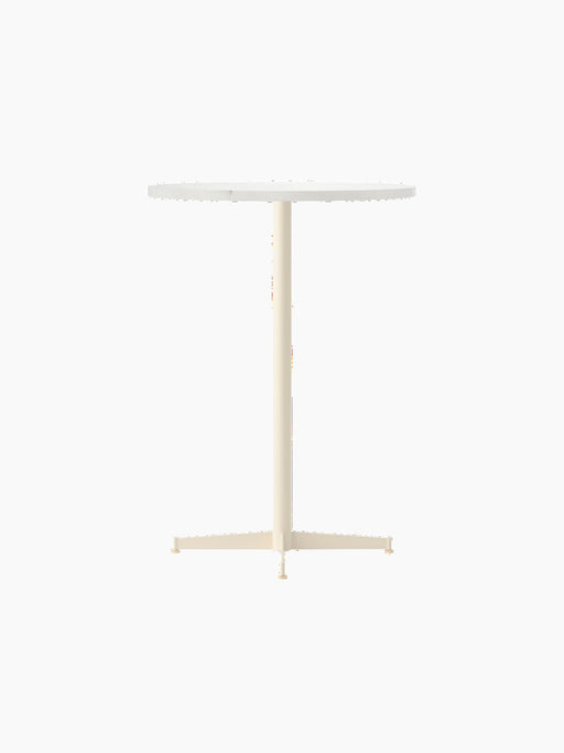 Angle view of the Nook Bar Table with a round white top and an ivory pedestal base with four feet, on a black background.