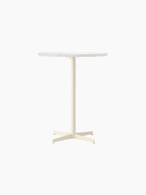 Front view of the Nook Counter Table with a round white tabletop and an ivory-coloured pedestal base with four feet.