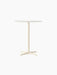 Front view of the Nook Counter Table with a round white tabletop and an ivory-coloured pedestal base with four feet.
