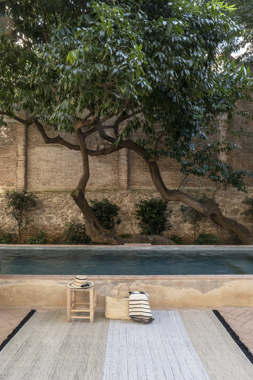 Tres Outdoor Stripes Black Rug in interior setting - nanimarquina