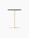 The Nook Bar Table seen from an angle, showing its dark circular tabletop and slender ivory-coloured pedestal base.