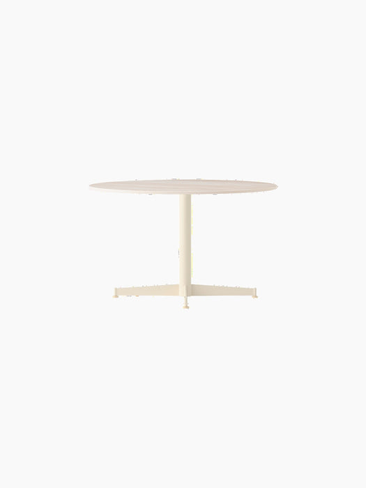 The Nook Lounge Table with an Estremoz Marble top and an ivory powder-coated steel four-star base against a black background.