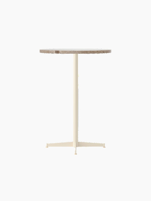 The Nook Bar Table with a round Kunis Breccia stone top and a slender, ivory powder-coated steel pedestal base.