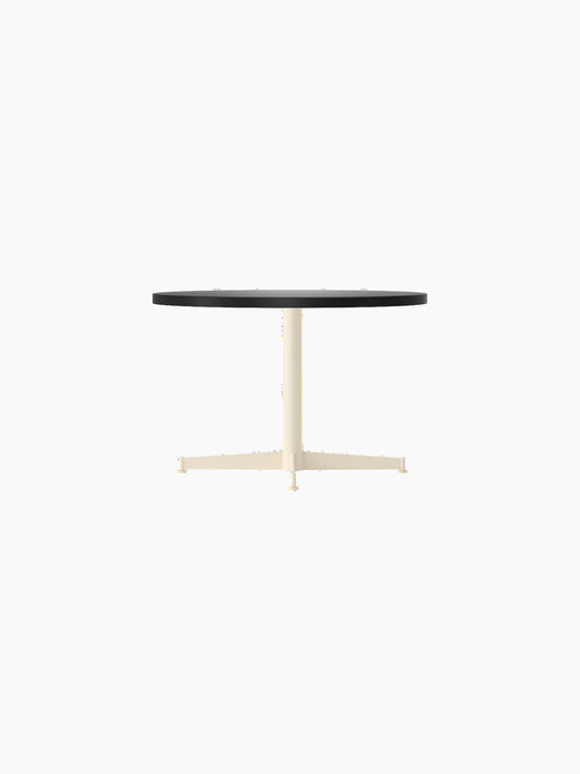 Side view of the Nook Lounge Table with a charcoal linoleum top and an ivory four-star base against a plain black background.