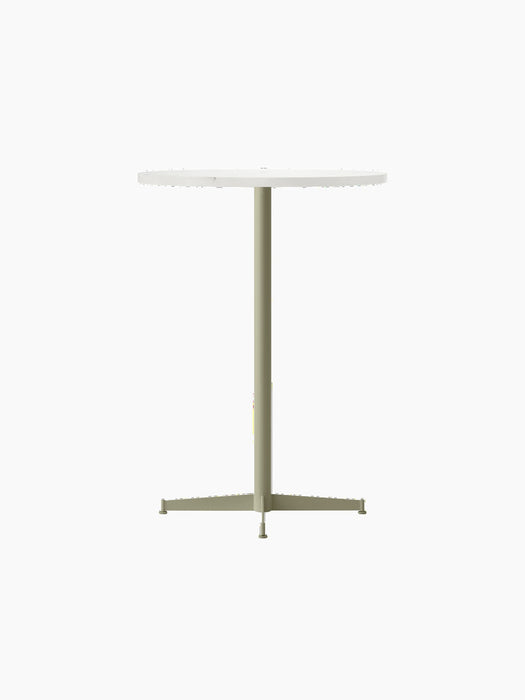 The Nook Bar Table shown from an angle, featuring a round white tabletop and a slim, ivory powder-coated steel pedestal base.