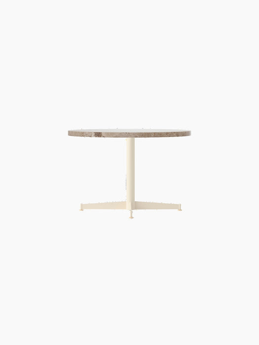Angle view of the Nook Lounge Table with a round Kunis Breccia stone top and an ivory powder-coated steel four-star base.