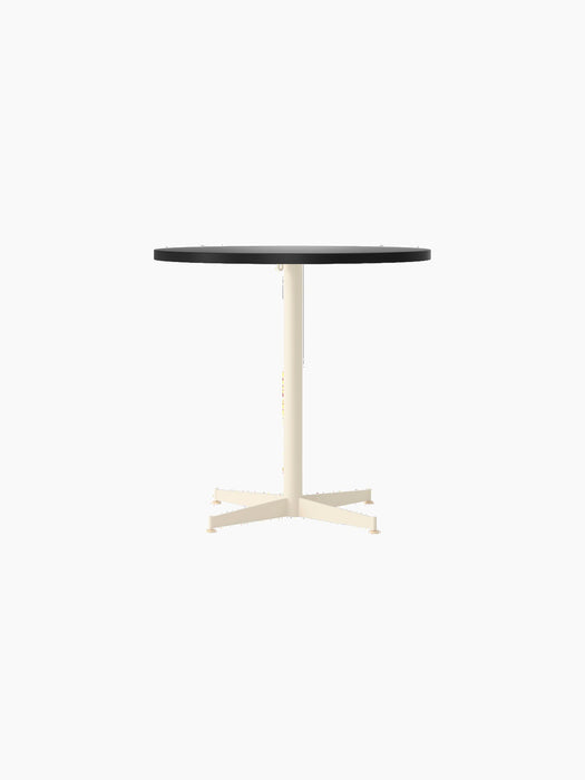 Front view of the Nook Dining Table with a round, charcoal linoleum tabletop and an ivory powder-coated steel four-star base.