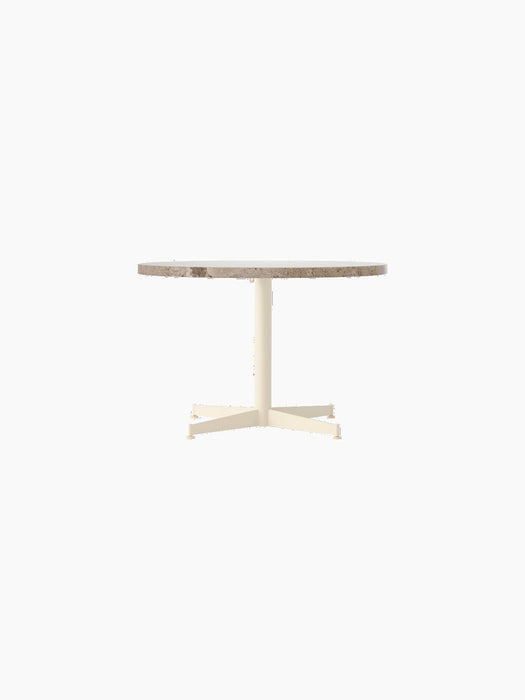 Front view of the Nook Lounge Table, featuring a round Kunis Breccia stone top and an ivory four-star pedestal base.