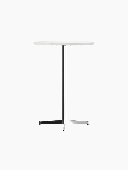 An angled, studio shot of the Nook Bar Table, featuring a round, light-coloured top and a slender black base with four feet.