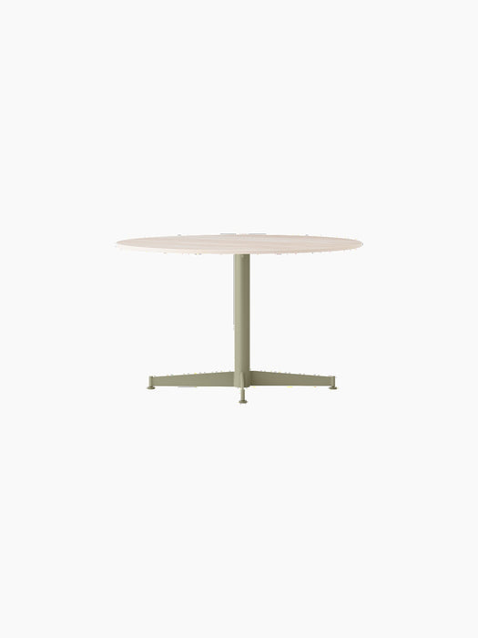 An angled view of the Nook Lounge Table, featuring a light-coloured stone top and an olive green four-star pedestal base.