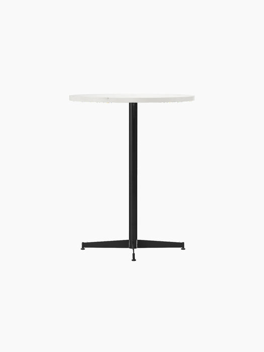 Angled view of the Nook Counter Table with a round, white tabletop, a slim black central pedestal, and a four-pronged base.