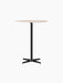 Front view of the Nook Bar Table featuring a light-coloured round marble top and a slender black powder-coated steel base.