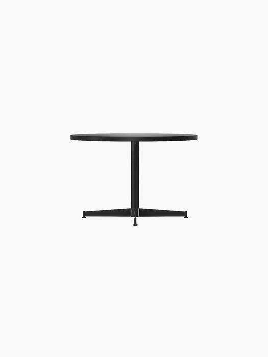 Side view of the black Nook Lounge Table, featuring a round top, a slender central stem, and a stable four-star base.