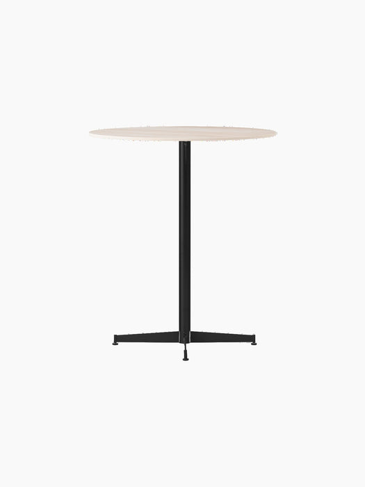 An angled view of the Nook Counter Table, showing its round Kunis Breccia stone top and slender black pedestal base.