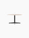 The Nook Lounge Table, shown at an angle, with a round, light-coloured stone top and a black four-star metal base.