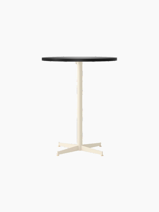 Front view of the Nook Counter Table, showing its round, dark charcoal tabletop and slim, ivory pedestal base with four feet.