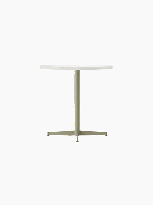 Front view of the Nook Dining Table with a round, light-coloured top and slender, olive four-star pedestal base.