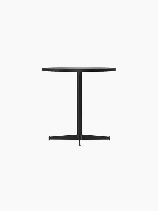 An angle view of the Nook Dining Table, showing its round dark top, slim central stem, and four-star base.
