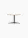 Angled view of the Nook Lounge Table, featuring a textured Kunis Breccia stone tabletop and a sleek black four-star base.