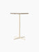 Front view of the Nook Bar Table with a round Kunis Breccia stone top on a slender ivory-coloured steel base with four feet.