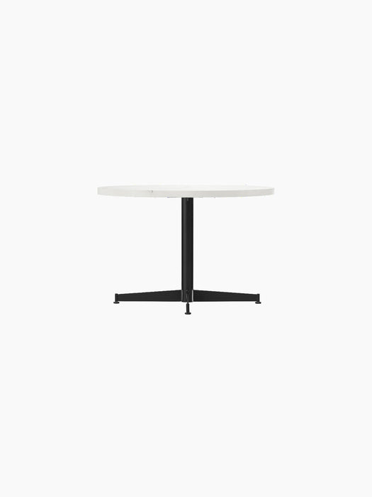 Nook Lounge Table shown from the front, with a round, light top and a slender black four-star base.