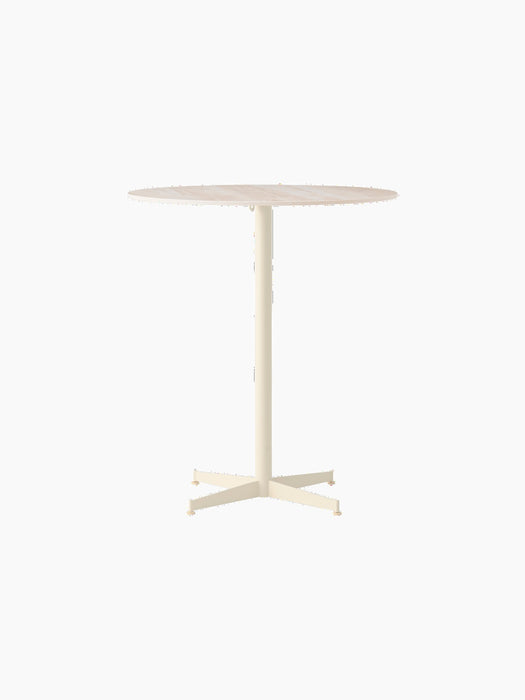 Front view of the Nook Counter Table, with a round, light-coloured marble top on a slim, ivory pedestal base with four feet.