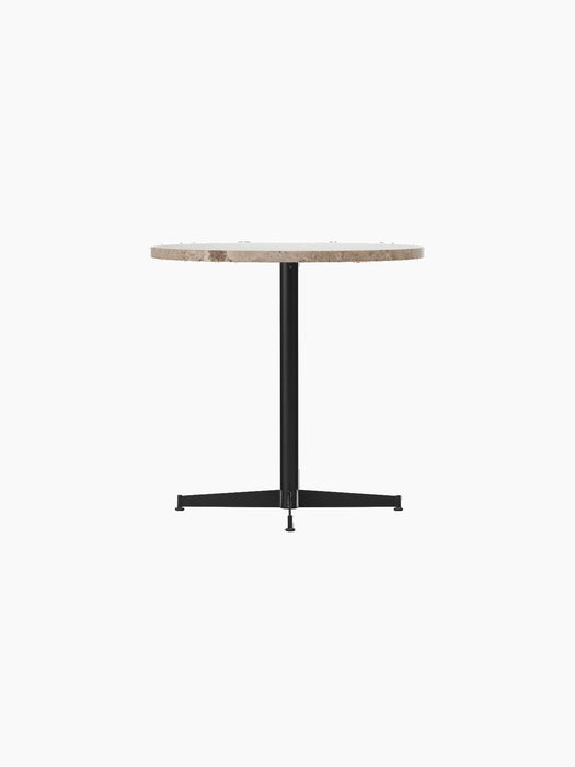An angled view of the Nook Dining Table, with a round Kunis Breccia stone top and a black powder-coated steel four-star base.