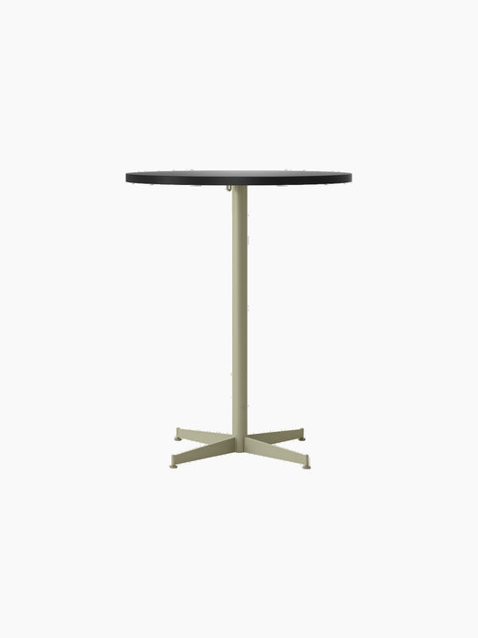Front-on photograph of the Nook Counter Table, showing its round, charcoal linoleum top and slim, olive-coloured metal base.