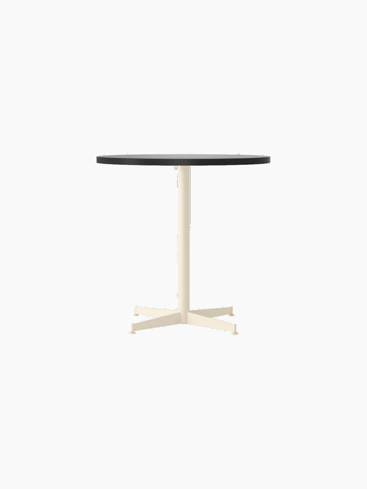 Front view of the round Nook Dining Table, featuring a dark top and a contrasting ivory-coloured, four-star pedestal base.