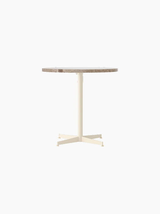 Front view of the Nook Dining Table with a round Kunis Breccia stone top and an ivory powder-coated steel four-star base.