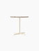 Front view of the Nook Dining Table with a round Kunis Breccia stone top and an ivory powder-coated steel four-star base.