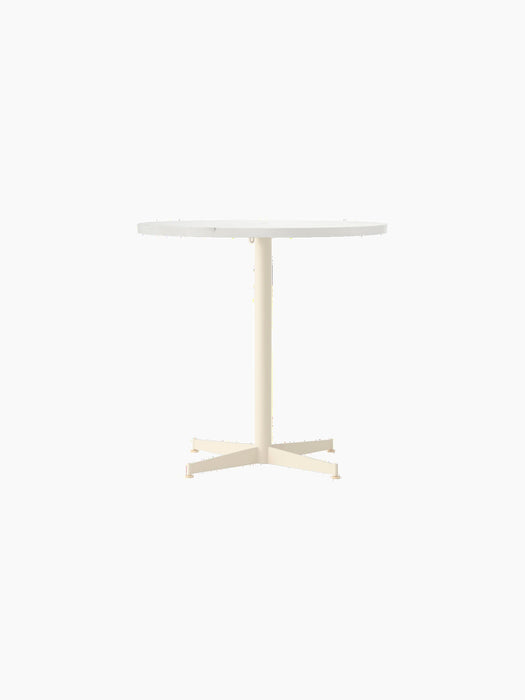 A front-on view of the Nook Dining Table, featuring a round, light-coloured stone top and an ivory powder-coated metal base.