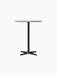 Front view of the Nook Counter Table with a round Kunis Breccia stone tabletop and a slender black powder-coated steel base.