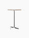 Front view of the Nook Bar Table with a round Kunis Breccia stone top and a slim black powder-coated steel pedestal base.
