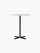 Front view of the Nook Counter Table, featuring a round Kunis Breccia stone tabletop on a black powder-coated steel base.