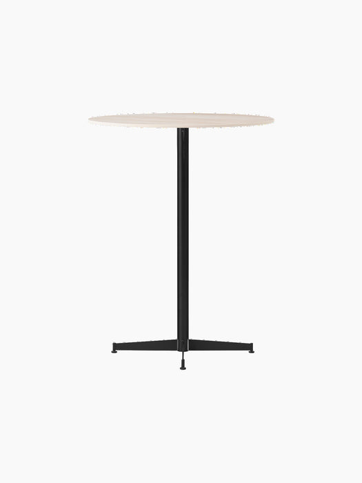 Angled view of the Nook Bar Table, with a round, light-coloured tabletop and a black powder-coated steel pedestal base.