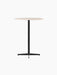 Angled view of the Nook Bar Table, with a round, light-coloured tabletop and a black powder-coated steel pedestal base.