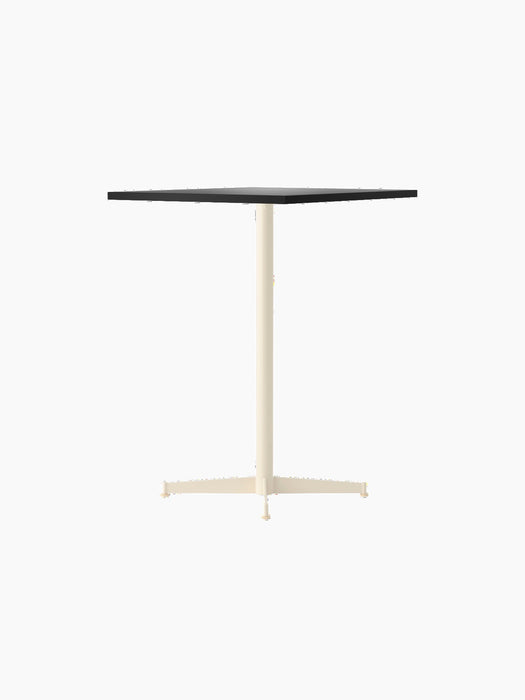 Angled view of the Nook Counter Table with a dark rectangular top and a contrasting ivory pedestal base.