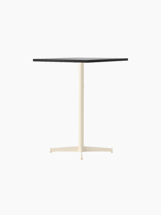 An angle view of the Nook Counter Table showing a rectangular stone-patterned top and slender, ivory-coloured pedestal base.