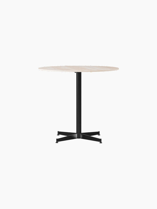 Front view of the Nook Dining Table with a round, light-coloured stone top and a black powder-coated steel four-star base.