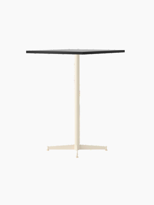 An angled shot of the Nook Bar Table, featuring a rectangular Kunis Breccia stone top and an ivory-coloured steel base.