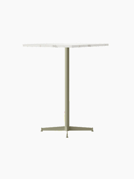 Angled view of the Nook Bar Table, featuring a round, white marble tabletop and a slender, ivory-coloured pedestal base.