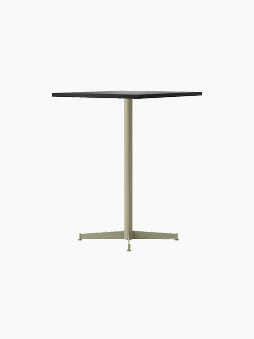 An angled view of the Nook Counter Table with a rectangular charcoal linoleum top on a slender olive pedestal base.