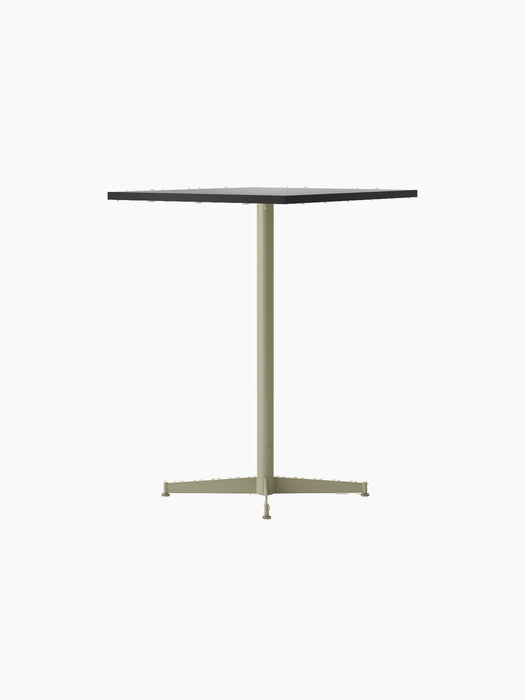 Angled view of the Nook Counter Table with a dark square top, a light-coloured single column, and a four-pronged base.