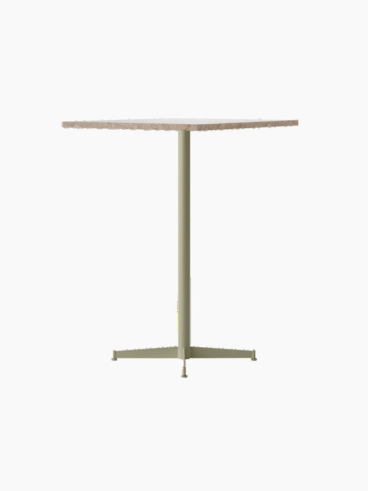 Angle view of the Nook Bar Table with a round Kunis Breccia stone top and an ivory powder-coated steel pedestal base.