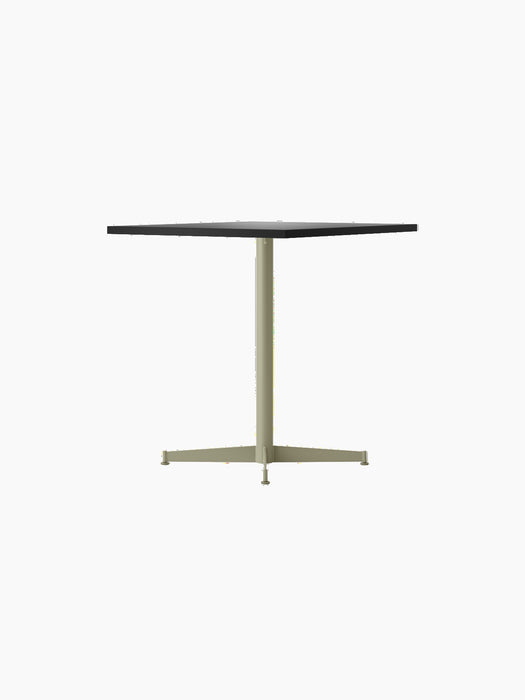 Side view of the Nook Dining Table, featuring a square dark grey top and a pale olive green single-stem, four-star base.