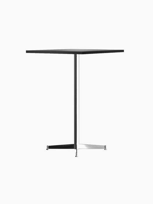 An angled profile of the Nook Bar Table, featuring a dark, thin tabletop and a black powder-coated steel stem and base.