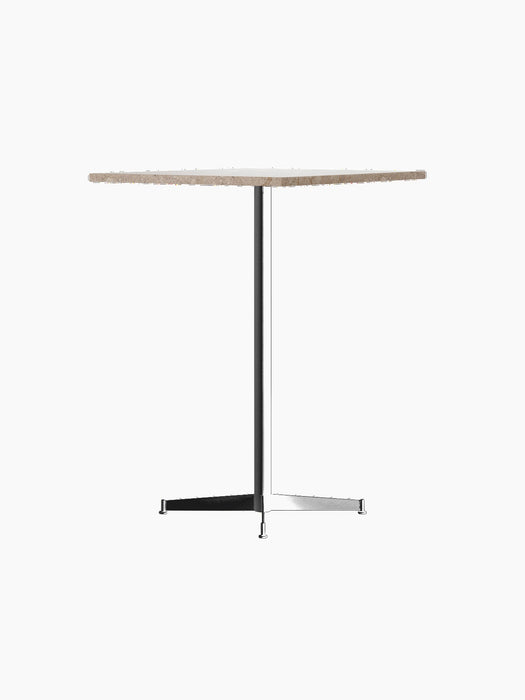 An angle view of the Nook Bar Table, featuring a round, textured stone top and a slender black steel pedestal base.