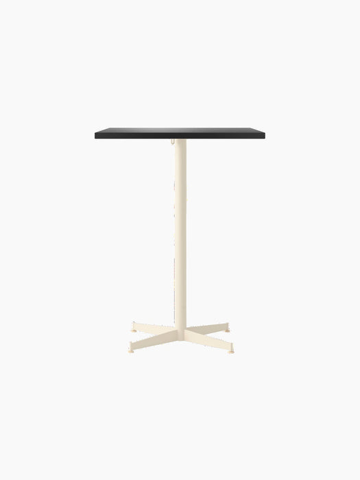 Front view of the Nook Counter Table with a rectangular dark grey top and a slender ivory pedestal on a black background.