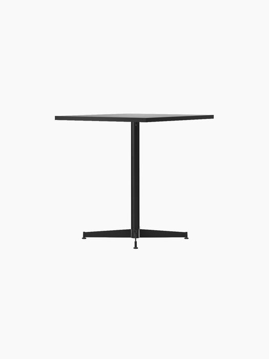 Angled view of the Nook Dining Table, its rectangular stone tabletop and slim, black powder-coated steel four-star base.
